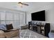 Living area with a large television and shuttered windows for ample natural light at 4020 E Toledo St # 103, Gilbert, AZ 85295