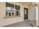 Covered front porch with large window and dark green front door at 4020 E Toledo St # 103, Gilbert, AZ 85295