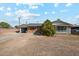 Charming single-story home with a brick facade, green roof, spacious front yard and attached garage at 4020 W Tuckey Ln, Phoenix, AZ 85019