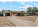 Cozy single-story brick home with an attached garage, a concrete driveway and a well-maintained front yard at 4020 W Tuckey Ln, Phoenix, AZ 85019