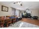 Cozy living room featuring tile flooring, ceiling fans, large windows, and a dining area at 4020 W Tuckey Ln, Phoenix, AZ 85019
