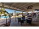 Spacious covered back patio offering both a lounge area and backyard games at 4245 N 16Th Dr, Phoenix, AZ 85015