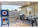 Backyard patio featuring a grill, games, outdoor lighting, and landscaped surroundings at 4245 N 16Th Dr, Phoenix, AZ 85015