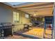 Large covered patio with a grill, games, and ceiling fans, providing an ideal space for outdoor gatherings at 4245 N 16Th Dr, Phoenix, AZ 85015