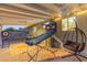 Spacious covered patio with games, comfortable seating, and ceiling fans, ideal for outdoor entertainment at 4245 N 16Th Dr, Phoenix, AZ 85015