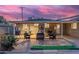 Charming covered patio with comfortable seating, games, and a putting green for outdoor fun at 4245 N 16Th Dr, Phoenix, AZ 85015