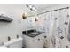 Bathroom featuring a vanity, sink, mirror, toilet, and tiled shower with a blue flower shower curtain at 4245 N 16Th Dr, Phoenix, AZ 85015
