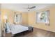 Bright bedroom featuring a ceiling fan, wood-look floors and two large windows offering natural light at 4245 N 16Th Dr, Phoenix, AZ 85015