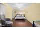 Spacious bedroom features wood floors, a ceiling fan, and comfortable seating area for versatile living at 4245 N 16Th Dr, Phoenix, AZ 85015