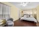 Cozy bedroom with wood floors, a comfortable bed, and an accent chair offers a relaxing retreat at 4245 N 16Th Dr, Phoenix, AZ 85015