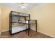Bedroom featuring a twin-over-twin bunk bed, natural light, and laminate flooring for a comfortable space at 4245 N 16Th Dr, Phoenix, AZ 85015