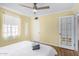 Bright bedroom features a ceiling fan and a white door leading to the bathroom at 4245 N 16Th Dr, Phoenix, AZ 85015