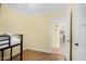 Bright bedroom featuring a twin bunk, wood-look floors and access to other rooms in the house at 4245 N 16Th Dr, Phoenix, AZ 85015