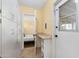 Hallway with white cabinets, shelving, and access to bedroom and exterior door at 4245 N 16Th Dr, Phoenix, AZ 85015