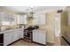 Bright kitchen boasts white cabinets, stainless steel appliances, and efficient layout at 4245 N 16Th Dr, Phoenix, AZ 85015
