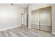 Bedroom featuring wood-look floors and sliding mirror closet doors at 4290 S Ramona St, Gilbert, AZ 85297