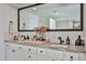 Bathroom features a large mirror, double sinks, and a decorative vase of flowers at 4434 E Camelback Rd # 132, Phoenix, AZ 85018