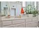Elegant bathroom with a marble vanity, stylish mirror, white cabinets, and decorative plants, creating a serene atmosphere at 4434 E Camelback Rd # 132, Phoenix, AZ 85018