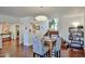 Dining area with a modern light fixture, hardwood floors, and staircase access at 4434 E Camelback Rd # 132, Phoenix, AZ 85018
