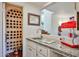 Unique kitchenette featuring a wine rack, granite countertops, stainless steel sink, and a convenient popcorn maker at 4434 E Camelback Rd # 132, Phoenix, AZ 85018