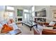 Bright living room featuring hardwood floors, a cozy fireplace, and large windows at 4434 E Camelback Rd # 132, Phoenix, AZ 85018