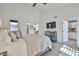 Bright main bedroom features a ceiling fan, TV, and view into an office and the main bathroom at 4434 E Camelback Rd # 132, Phoenix, AZ 85018