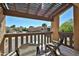 Comfortable balcony with seating area and trellised roof offers a serene outdoor space at 4434 E Camelback Rd # 132, Phoenix, AZ 85018