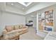 Sitting area with a comfortable couch and ottoman, skylight, and collage wall at 4434 E Camelback Rd # 132, Phoenix, AZ 85018