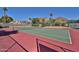 A community tennis court against a backdrop of majestic mountains and palm trees, offering a picturesque recreational setting at 4434 E Camelback Rd # 132, Phoenix, AZ 85018
