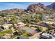 Aerial view of community tennis courts surrounded by lush greenery and mountain views at 4434 E Camelback Rd # 132, Phoenix, AZ 85018