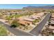 Aerial view of a desert community, highlighting a mix of single-story homes and lush green golf courses at 6620 S Front Nine Dr, Gold Canyon, AZ 85118