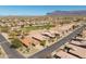 Expansive aerial view of homes in a desert community near a golf course with mountain views at 6620 S Front Nine Dr, Gold Canyon, AZ 85118