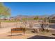 Back patio with wrought iron fence overlooking desert landscape with swimming pool and mountain views at 6620 S Front Nine Dr, Gold Canyon, AZ 85118