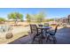 Outdoor patio area featuring a table, chairs, and beautiful views of the golf course and mountains at 6620 S Front Nine Dr, Gold Canyon, AZ 85118
