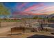 Expansive backyard featuring a bench, private pool, and stunning mountain views at sunset at 6620 S Front Nine Dr, Gold Canyon, AZ 85118