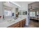Bathroom featuring double sinks, a soaking tub, and a view to the bedroom at 6620 S Front Nine Dr, Gold Canyon, AZ 85118