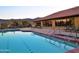 Inviting community pool reflecting the building and sunset sky at 6620 S Front Nine Dr, Gold Canyon, AZ 85118