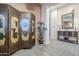 Inviting entryway featuring neutral tones, decorative screen, stylish console table and elegant mirror at 6620 S Front Nine Dr, Gold Canyon, AZ 85118