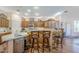 Well-lit kitchen featuring a granite countertop island with chairs and wooden cabinets at 6620 S Front Nine Dr, Gold Canyon, AZ 85118