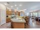 Open kitchen with a large island, granite countertops, wooden cabinets, and access to the living area at 6620 S Front Nine Dr, Gold Canyon, AZ 85118