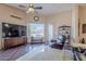 Living room features hardwood floors, large TV, leather chair and views to backyard at 6620 S Front Nine Dr, Gold Canyon, AZ 85118