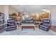 Open living room with hardwood floors, fireplace, leather furniture, and an open kitchen at 6620 S Front Nine Dr, Gold Canyon, AZ 85118