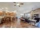 Open-concept living room featuring hardwood floors, ceiling fans, and a kitchen bar at 6620 S Front Nine Dr, Gold Canyon, AZ 85118