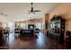 Spacious living room with hardwood floors, multiple ceiling fans and large windows with outdoor views at 6620 S Front Nine Dr, Gold Canyon, AZ 85118