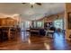 Expansive living space with hardwood floors and ceiling fans flows seamlessly into the kitchen area at 6620 S Front Nine Dr, Gold Canyon, AZ 85118