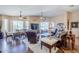 Bright living room with hardwood floors, multiple windows, and comfortable leather furniture at 6620 S Front Nine Dr, Gold Canyon, AZ 85118