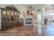 Living room area featuring a fireplace, hardwood floors, and a display cabinet at 6620 S Front Nine Dr, Gold Canyon, AZ 85118