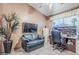 Home office with a comfortable black sofa, TV, and built-in desk at 6620 S Front Nine Dr, Gold Canyon, AZ 85118