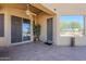 Covered outdoor patio with desert landscaping views from a sliding glass door and adjacent windows at 6620 S Front Nine Dr, Gold Canyon, AZ 85118