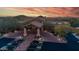 Stunning aerial view of the property entrance and lush landscaping with mountain views at sunset at 7304 E Northridge Cir, Mesa, AZ 85207